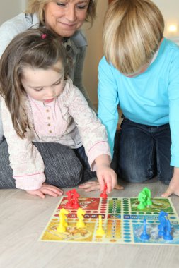 Grandmother watching her grandchildren play a game clipart