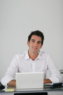 Businessman using a netbook clipart