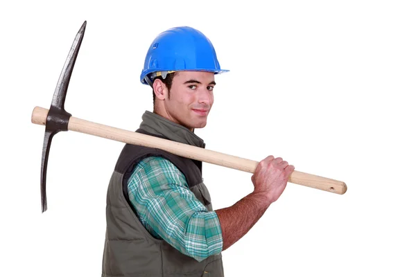A worker holding a pickaxe. — Stock Photo, Image