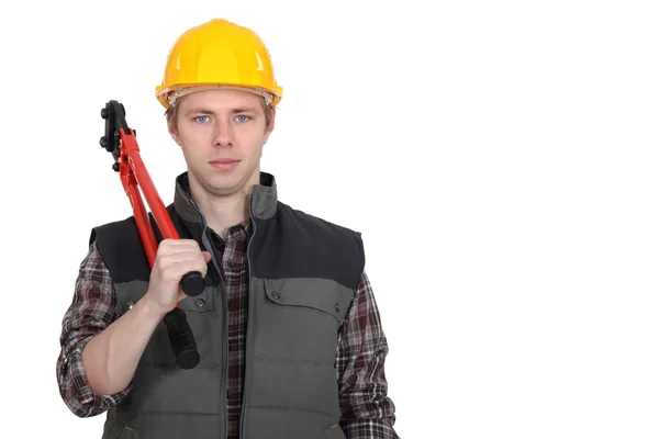 Een bouwvakker met een tang. — Stockfoto
