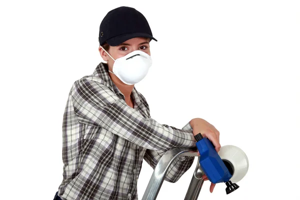 stock image Craftswoman on a ladder holding a sprayer