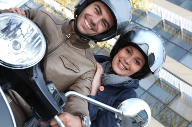 Couple riding a motor bike clipart