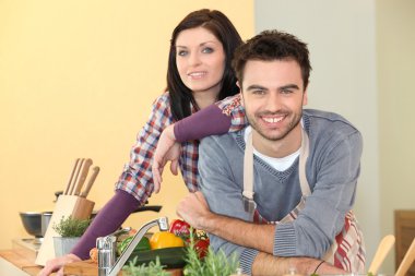 Couple preparing a meal together clipart