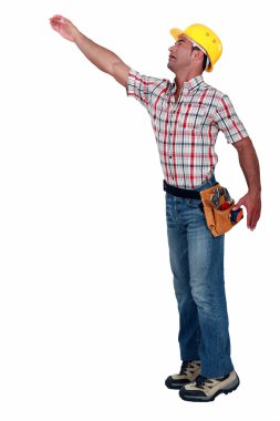 Construction worker reaching for something clipart