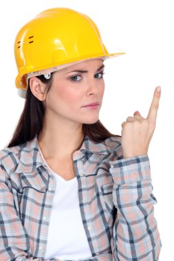 Portrait of young craftswomen looking concerned pointing upwards clipart