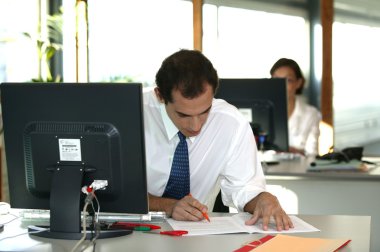 Office worker reviewing a file clipart