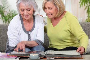 Older women looking at a photo album clipart