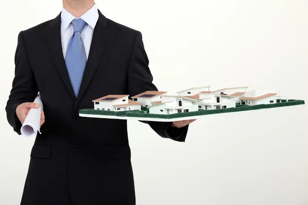 Architect with a model of a new housing estate — Stock Photo, Image