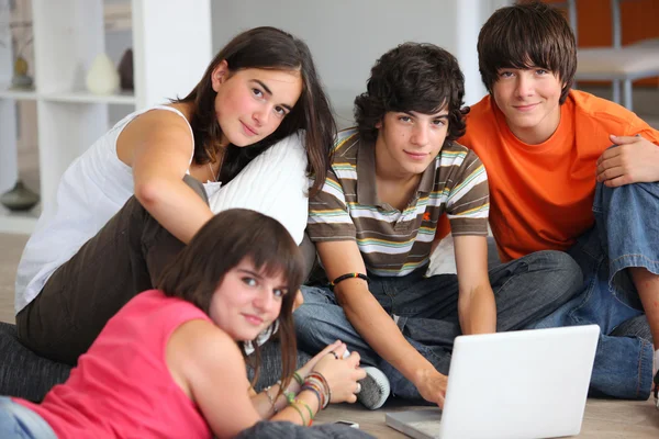 Tonåringar har kul med en bärbar dator hemma — Stockfoto