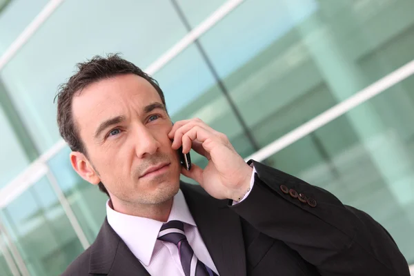 Businessman having phone conversation outdoors — Stock Photo, Image
