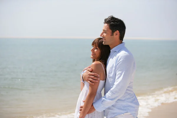 Par som står på en strand — Stockfoto