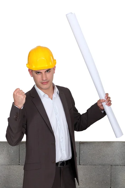 Successful architect in front of wall — Stock Photo, Image