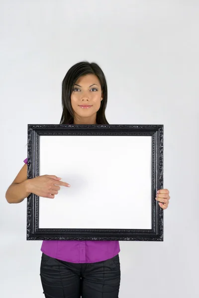 Woman with a blank picture frame — Stock Photo, Image