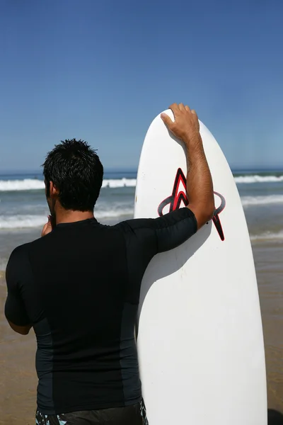 Junger Mann mit Surfbrett — Stockfoto