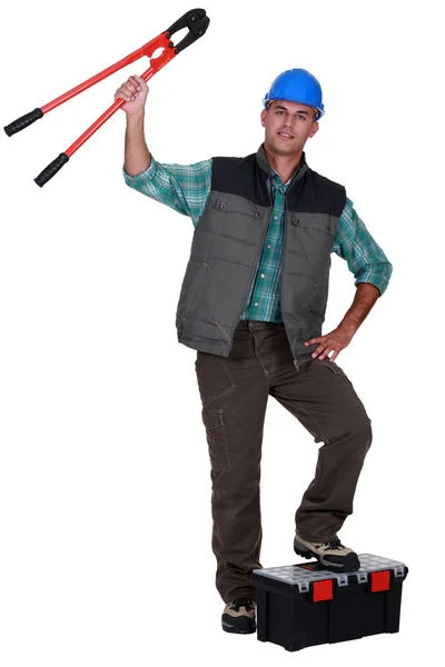 Tradesman holding up a pair of large clippers — Stock Photo, Image