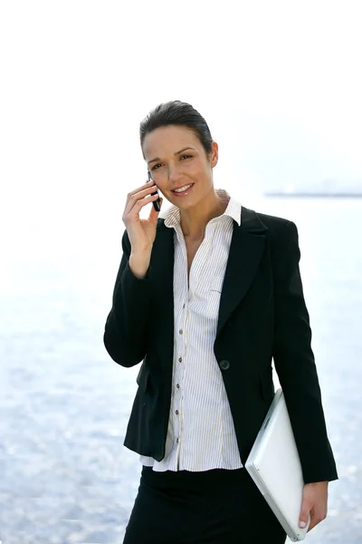Smart businesswoman on cellphone outdoors — Stock Photo, Image