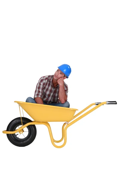 Building worker resting in a barrow — Stock Photo, Image