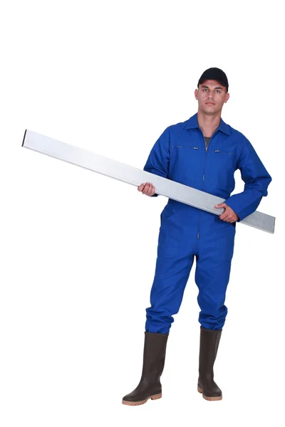 Tradesman carrying a girder — Stock Photo, Image