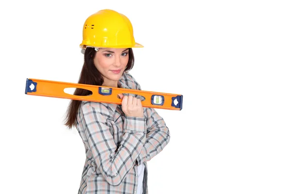 Woman with a spirit level — Stock Photo, Image