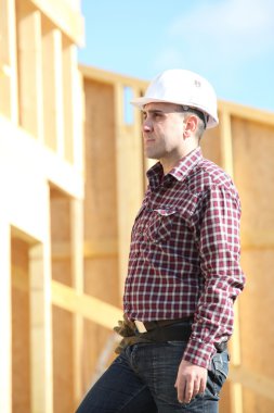 Craftsman building a wooden house clipart