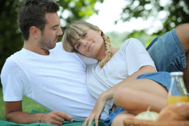 Couple enjoying a picnic together clipart