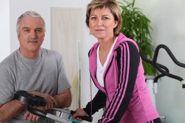 Married couple working out in a gym clipart