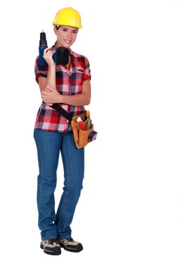 Tradeswoman holding a power tool clipart