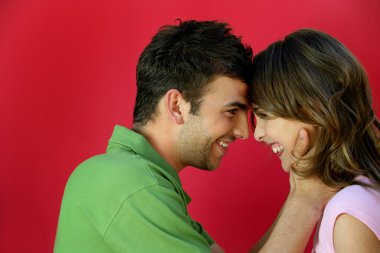 Affectionate couple stood facing each other clipart