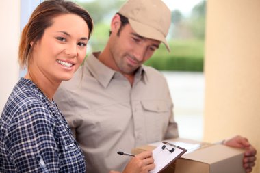 Woman signing for a package clipart