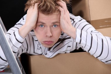 Overwhelmed man on moving day clipart