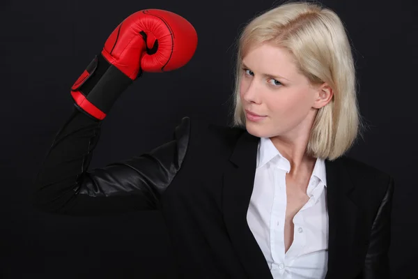 Businesswoman with a boxing glove — Stock Photo, Image