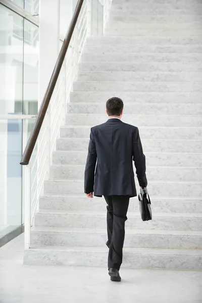 Businessman going upstairs — Stock Photo, Image