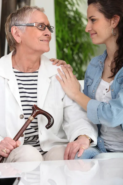 Old lady with young carer — Stock Photo, Image