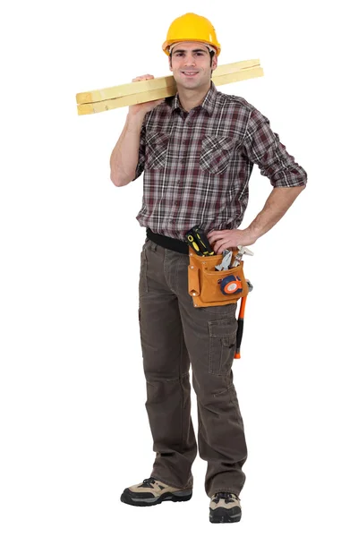 Mason carrying two wooden planks — Stock Photo, Image