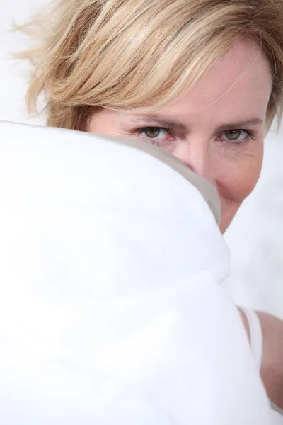 Wife behind pillow — Stock Photo, Image