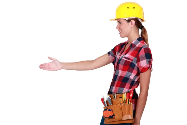 A female construction worker about to shake hands. — Stock Photo, Image