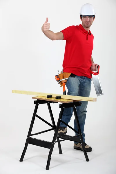 Confident laborer with saw — Stock Photo, Image