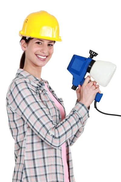 Young woman with spray for painting Stock Picture