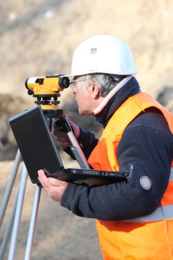 Site surveyor taking readings clipart
