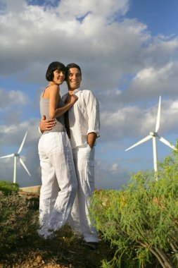 Couple in front of wind farm clipart