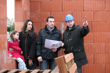 Couple having their new home inspected by an engineer clipart