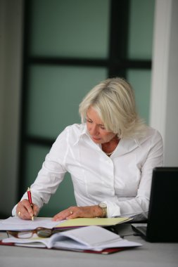 Secretary filling in paperwork clipart