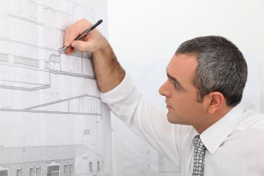Architect working on a blueprint clipart