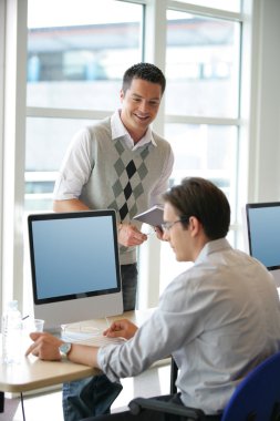 Men at an office computer clipart