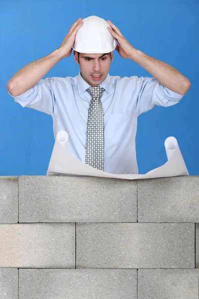 Stressed architect reviewing plans — Stock Photo, Image