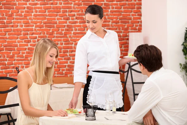 Couple and waitress at restaurant Stock Photo
