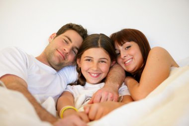 Couple and daughter in bed clipart