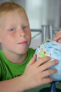 Fair-skinned boy playing with a toy clipart