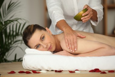 Woman receiving massage clipart