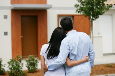 Couple looking at their new home clipart